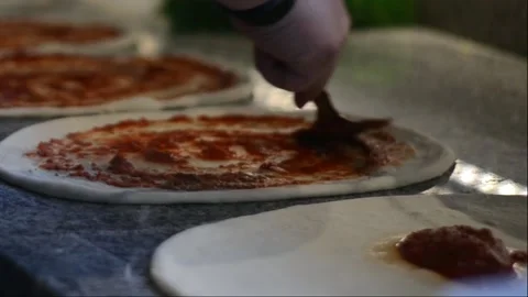 Pizza preparation setting up the sauce Stock Footage 151927924