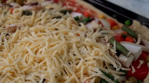 Pizza preparing adding cheese close up footage Stock Footage 84098917