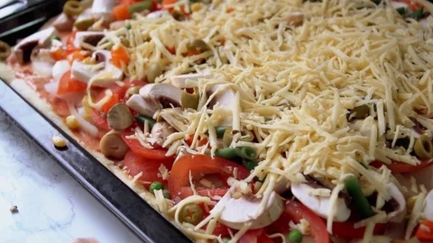 Pizza preparing adding cheese close up footage Stock Footage 84098945