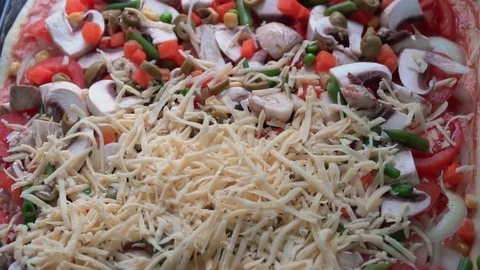 Pizza preparing adding cheese close up footage Stock Footage 84099783