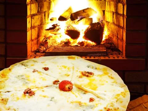 Pizza quatro formaggi and open fire in oven Stock Photos