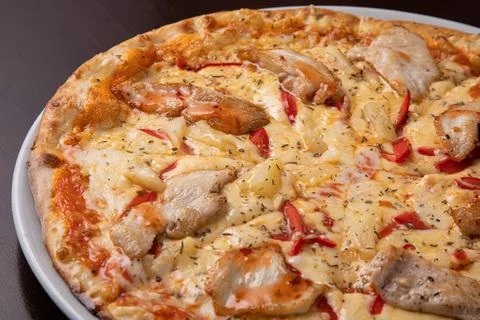 Pizza quattro stagioni four seasons pizza with cheese and chicken Stock Photos