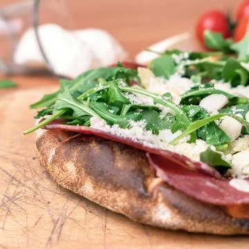 Pizza with raw ham Stock Photos