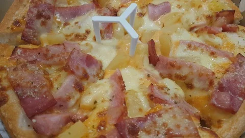 The pizza rotates on the paper tray. Stock Footage 100548360