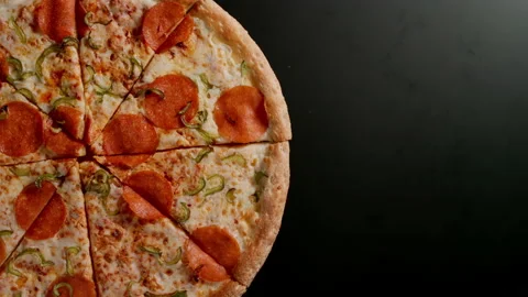 Pizza Is Rotating On A Black Table In Left side Stock Footage 147109546
