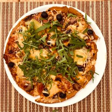 Pizza with rucola Stock Photos