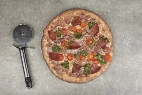 Pizza with salami on a kitchen table Stock Photos