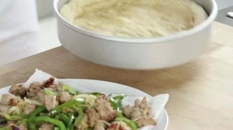Pizza sauce being spread on the prebaked pizza base Stock Footage 24672606