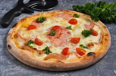 Pizza with scrambled eggs, ham, cherry tomatoes, greens Stock Photos