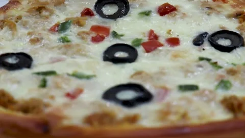 Pizza slice close up with gooey cheese tender chicken toppings olives Stock Footage 338164204