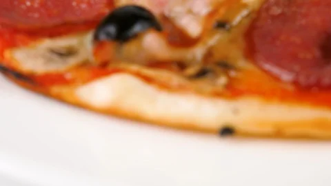 Pizza with sliced ham, salami, bacon, mushrooms and black olives Stock Footage 87689783