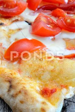 Pizza with sliced tomatoes Stock Photos
