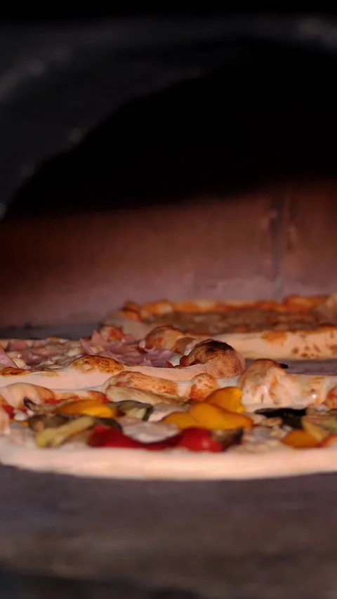 A pizza with spinach and cheese is being cooked in an oven. The Pizza is placed Stock Footage 314115533