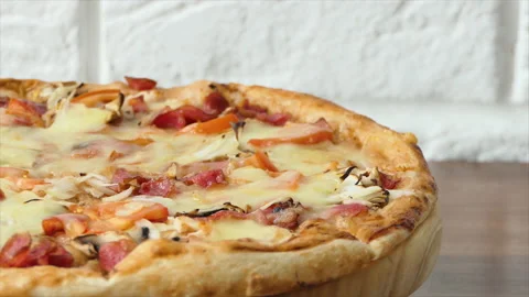 Pizza spinning on plate, back background. Close up shot of delicious pepperoni Stock Footage 195125230