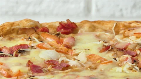 Pizza spinning on plate, back background. Close up shot of delicious pepperoni Stock Footage 195452108