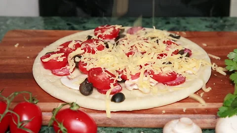 Pizza is sprinkled with cheese Stock Footage 142144770