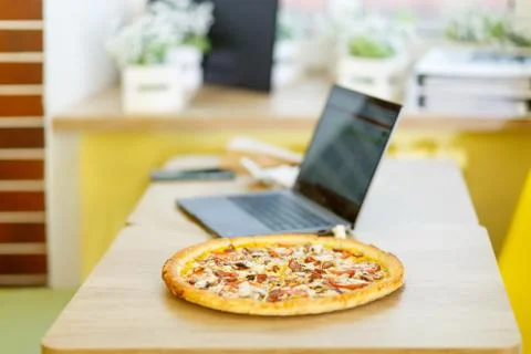 Pizza stands on a table in a cafe. Stock Photos