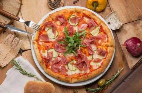 The pizza on the table and vegetables Stock Photos