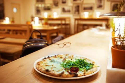 Pizza on the table in the cafe. Stock Photos