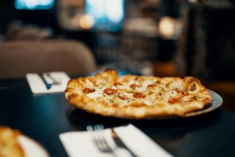 Pizza on a table at a restaurant Stock Photos