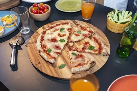 Pizza on a table with varius elements Stock Photos