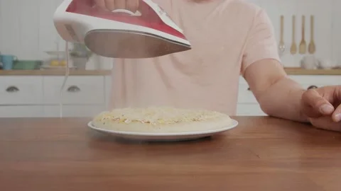 The pizza on the table which is steamed with an iron by the freaky man Stock-Footage 144018268