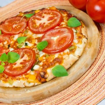 Pizza with tomatoes Stock Photos
