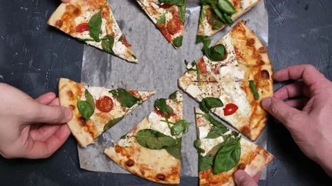Pizza top view. Hands pick up pieces of hot pizza close-up slow mo Stock Footage 169186228
