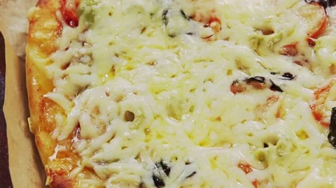 A pizza topped with mozzarella and cherry tomatoes, baking in the oven Stock Footage 67358005