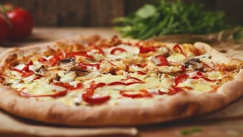Pizza on wooden table Stock Footage 75175571
