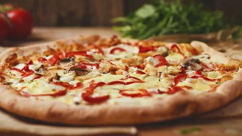 Pizza on wooden table Stock Footage 75175598