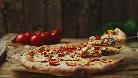 Pizza on wooden table Stock Footage 75298638