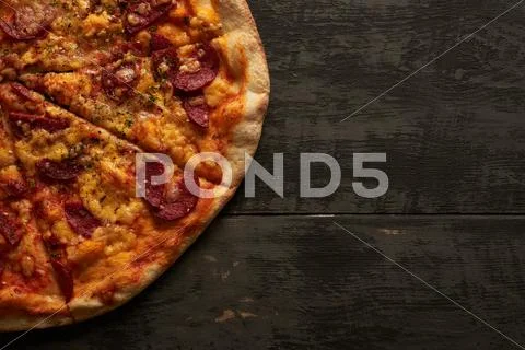Pizza on a wooden table Stock Photos