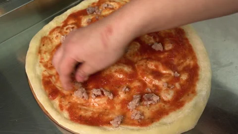 Pizzaiolo making pizza. Chef preparing pizza in the restaurant kitchen. The Video stock 179330013