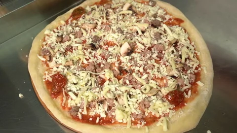 Pizzaiolo making pizza. Chef preparing pizza in the restaurant kitchen. The Stock Footage 179843982