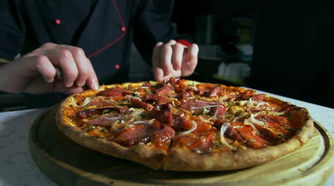 Pizzaiolo preparing a pizza for serving Stock Footage 41939998