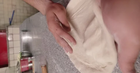 Pizzaiolo stretching dough by hands to make pizza. Pizza preparation Stock Footage 263672446