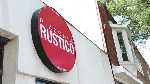 Pizzeria rustico since 2004 circle red sign logo on front of store restaurant Stock Footage 251355245