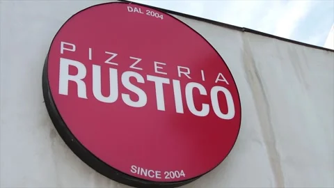Pizzeria rustico since 2004 circle red sign logo on front of store restaurant Stock Footage 251355591