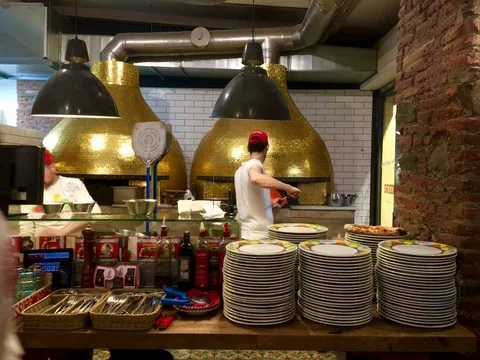 Pizzeria.  Two men is baking pizza in the oven. Milan. Italy 03/03/2018 Stock Footage 95544932
