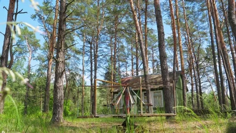 PKV17309Long shot of rusty carousel in a pine forest Stock Footage 162879515