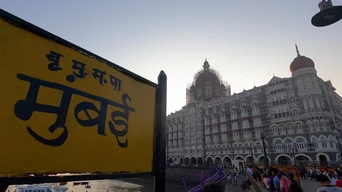Placard / Sign board of Mumbai outside Gateway of India, Taj Mahal Palace Hotel Stock Footage 123748324