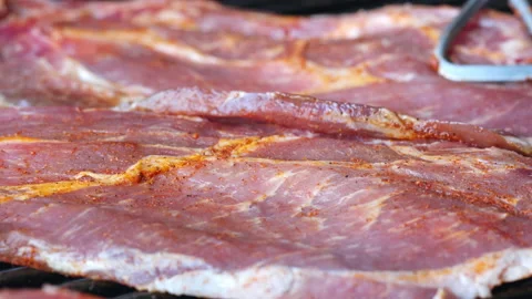 Place another slice of meat, which has already been seasoned, on a hot grill. Stock Footage 163051691