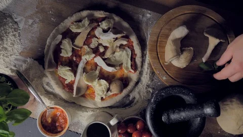 Place basil on the pizza. Very appetizing Stock Footage 108143839
