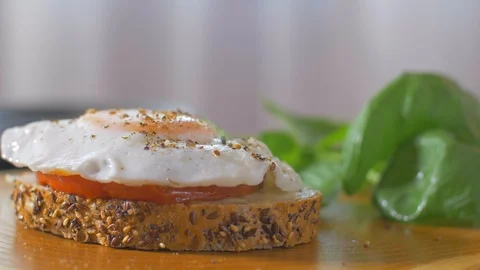 Place basil on sandwich with egg Stock Footage 109550881