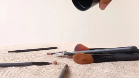 Place the black brushes onto a brown table Stock Footage 146253199