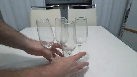Place champagne glasses on the kitchen table. Empty champagne glasses Stock Footage 336466339