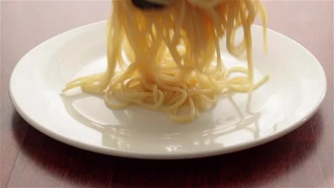 Place cooked hot spaghetti on white plate Stock Footage 154347797