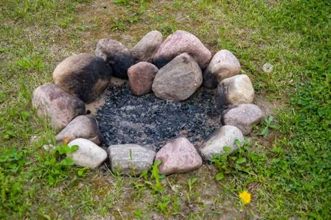 Place for a fire in nature, stone-lined fireplace in the middle of the grass Stock Photos