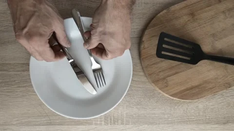 Place fork and knife over plate Stock Footage 121826783